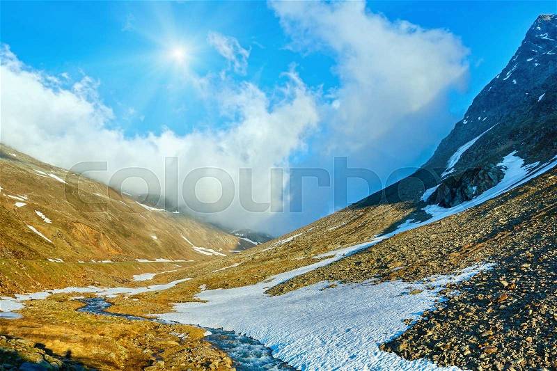 Mountain spring stream and sun (near Timmelsjoch - high alpine road on Italian - Austria border), stock photo