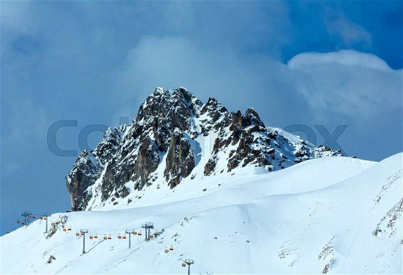 Winter rocky mount top (Tyrol, Austria) and ski lift on slope. , stock photo