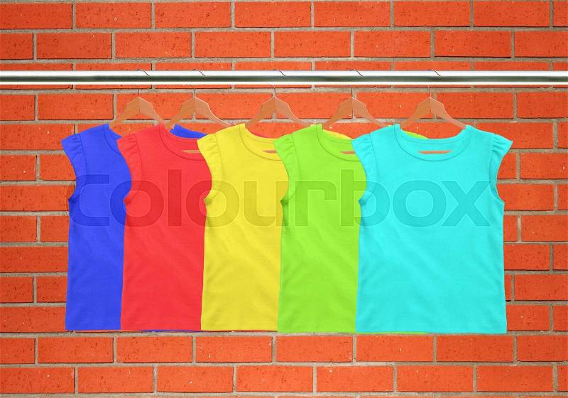 Clothes on circle hanger on brick wall background, stock photo