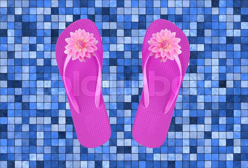 Pink beach shoes with flowers on blue pool tile, stock photo