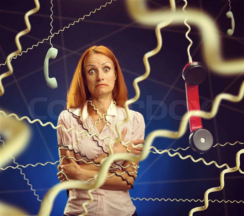 Stressed telephone worker in the net of wires, stock photo