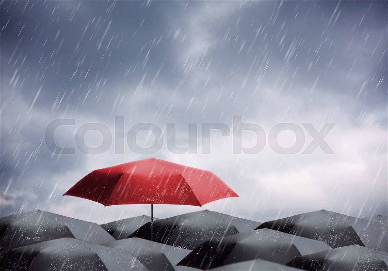 Black and one red umbrellas under rain and thunderstorm, stock photo