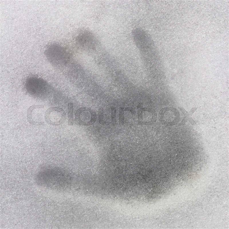 Horizontal view of a handprint on icy snow, stock photo