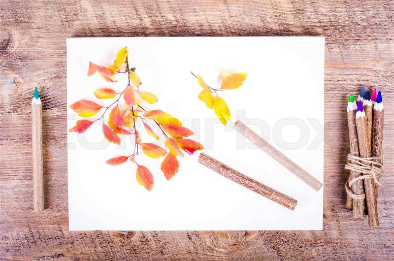 Colorful autumn leaves and pensils lying on diary, notebook, paper, wooden background. Fall and thanksgiving. Autumn composition. Free space for text, stock photo