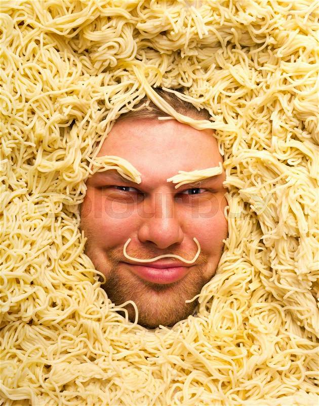 Happy man\'s face in pasta, closeup, stock photo