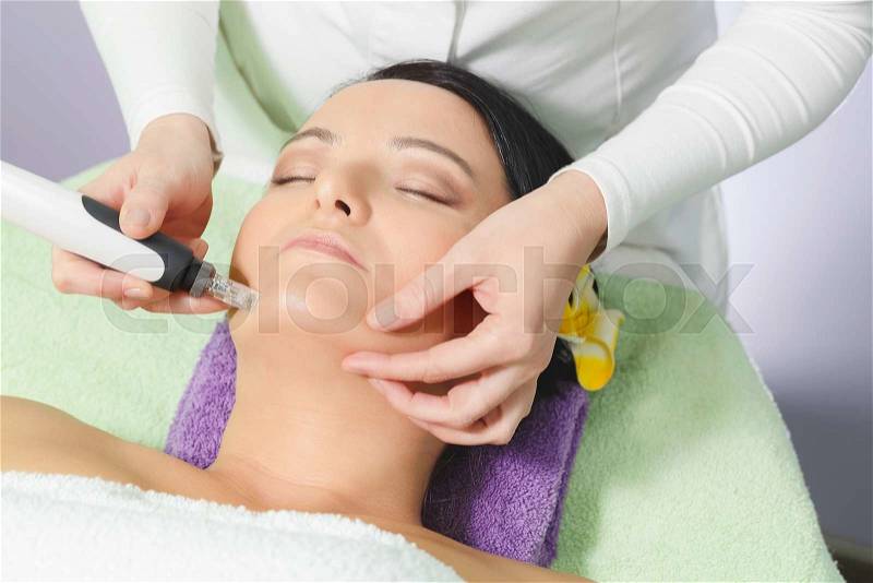Mesotherapy, anti ageing treatment. Woman having mesotherapy facial treatment at beauty salon, stock photo