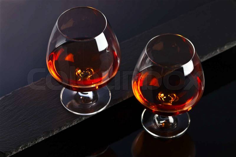 Snifter with brandy on a black background, stock photo