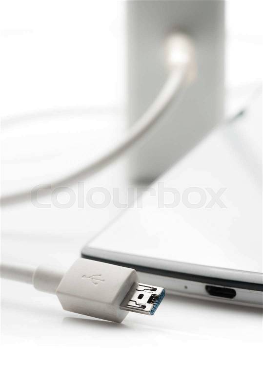Smartphone with charger on white background,USB cable, stock photo