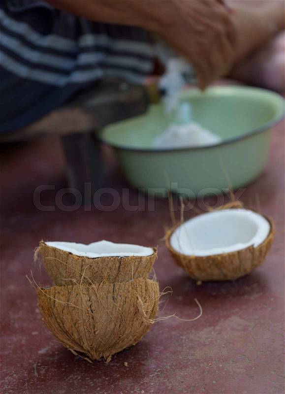 People making coconut for food ingredient with tradition Thai tool, stock photo