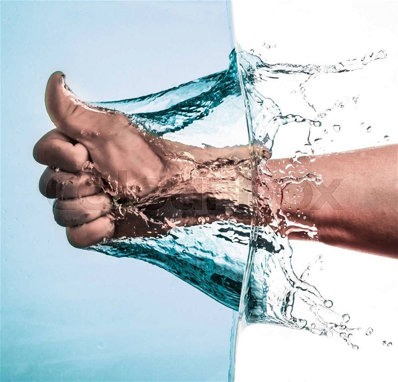 Male Fist through the Blue Water and splashing drops,Like hand sign, stock photo