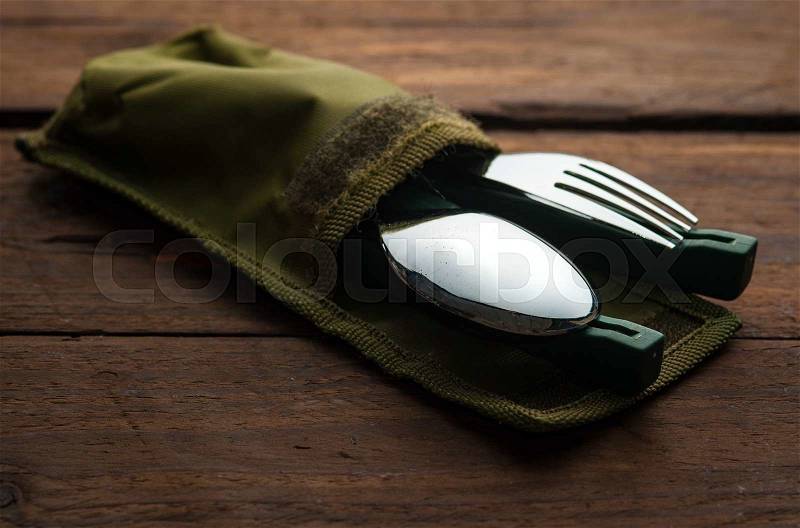 Pocket army fork and spoon on wood, stock photo