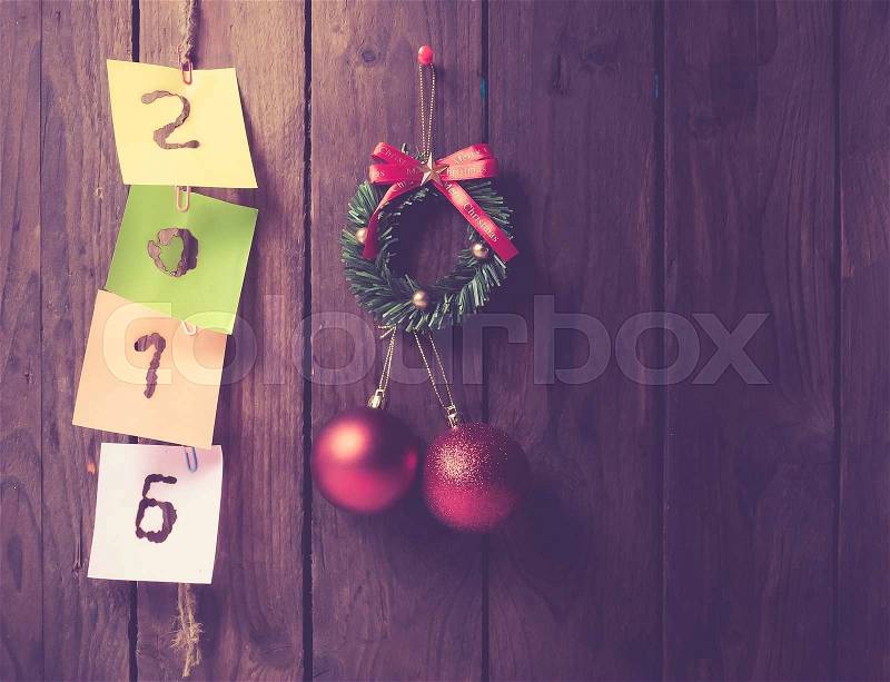 New year 2016 of burned in papernote on a wooden background,vintage color toned image, stock photo