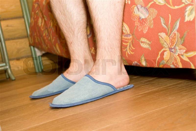 Man\'s legs in slippers, stock photo