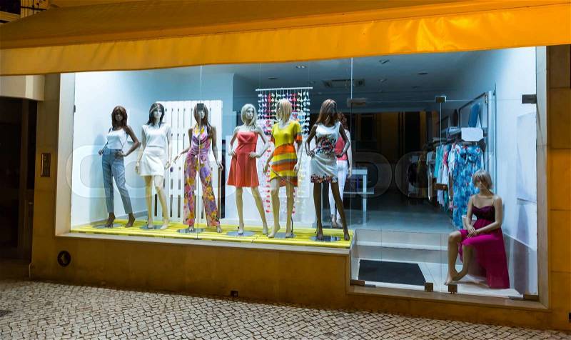 Storefront with women mannequins in fashionable dresses, stock photo