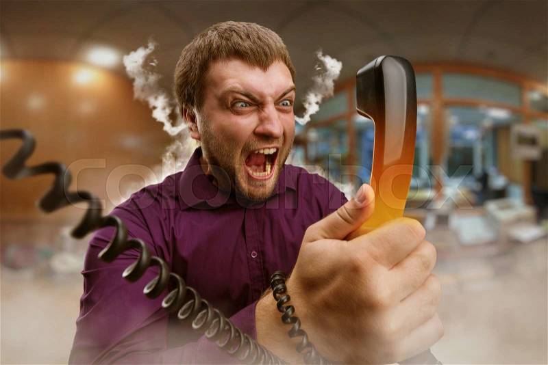 Angry bearded man screaming into the phone, stock photo