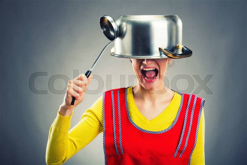 Crazy housewife with sause pan on her head, stock photo