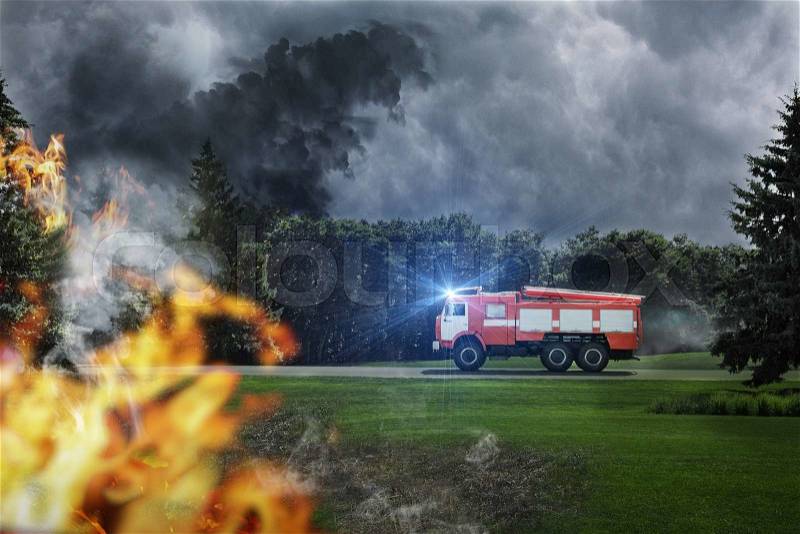 Fire-engine is in hurry to extinguish dangerous fire in the forest, stock photo
