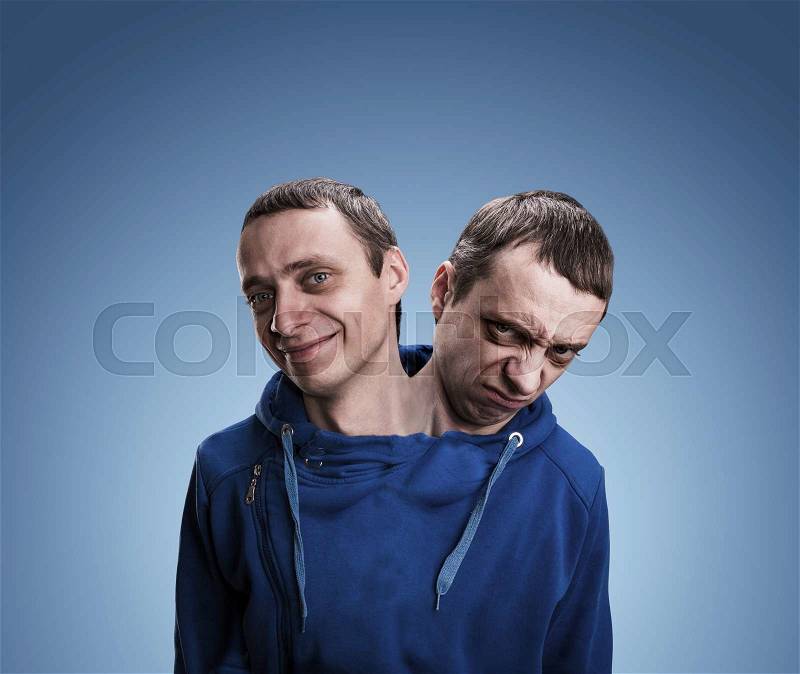 A man with two heads over blue background, stock photo