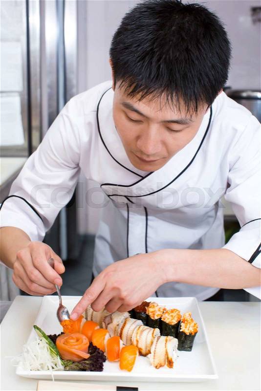 Japanese chef preparing a meal in a restaurant, stock photo