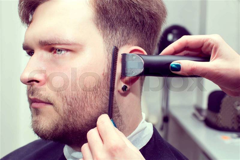 Men\'s haircut in the salon barbershop beard closeup, stock photo