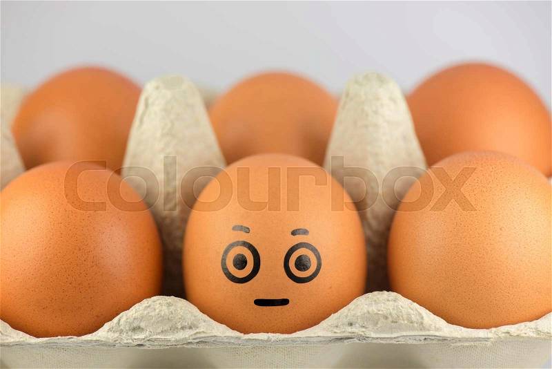 Egg with a face in a egg carton , stock photo