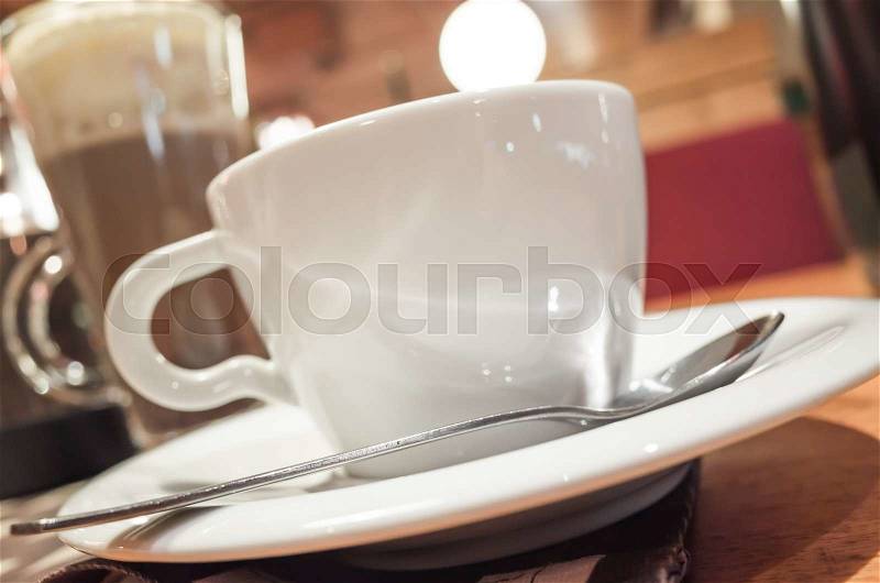 Cup of coffee stands on a table in cafeteria, photo with selective focus and shallow DOF, stock photo