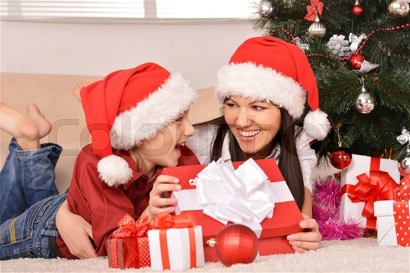 Cute mom and son in santa hats, stock photo