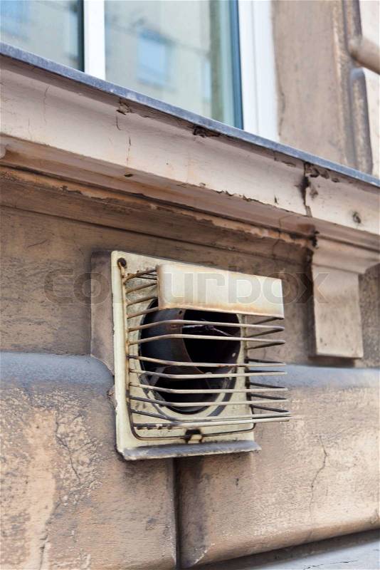 Exhaust chimney of an old gas heater in a house wall, stock photo