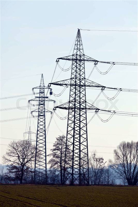 Poles of a high-voltage power line. Production and transportation of energy, stock photo