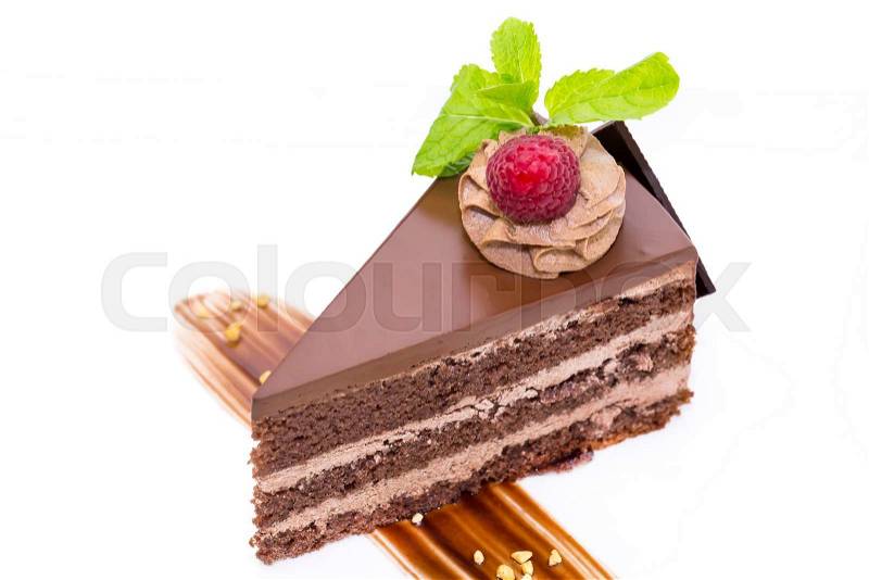 Prague piece of cake decorated with raspberries on a white background, stock photo