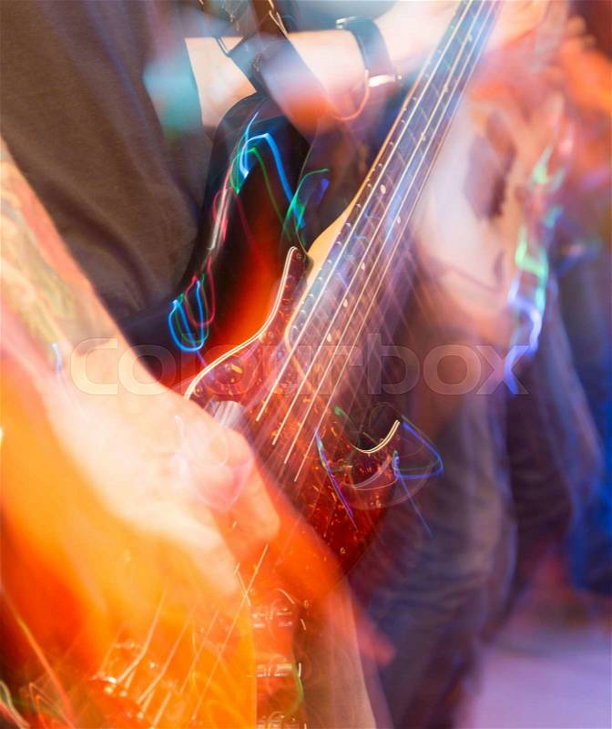 Aggressive play guitar on stage, stock photo