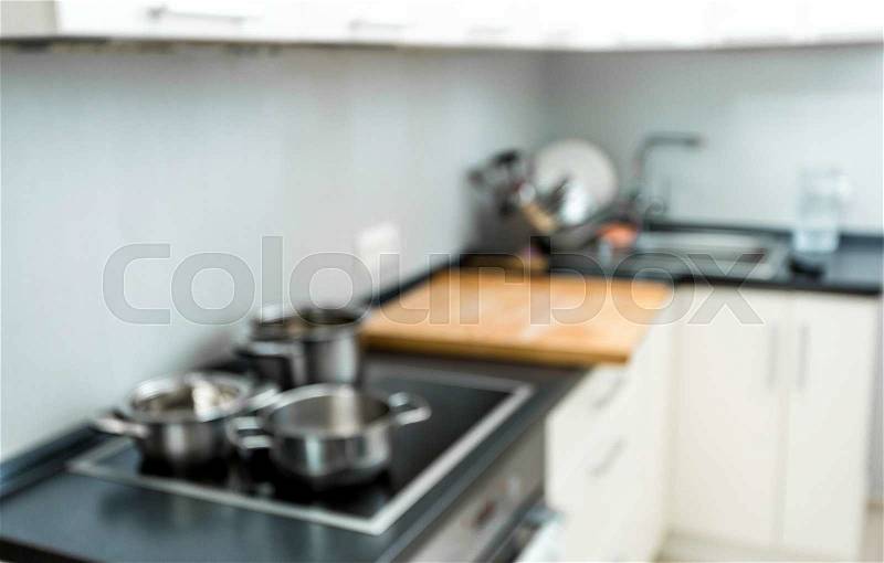 Blurred background of modern kitchen at home with electric oven, stock photo