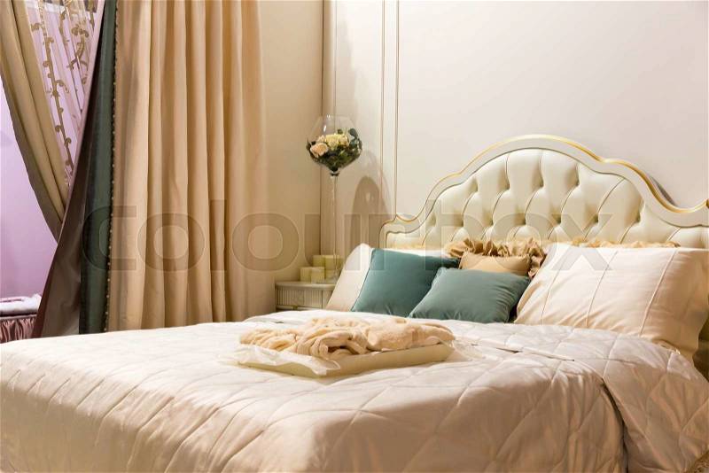 Vintage bedroom interior. Bed with pillows, stock photo