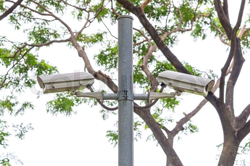 Security CCTV camera and urban video at public park, stock photo