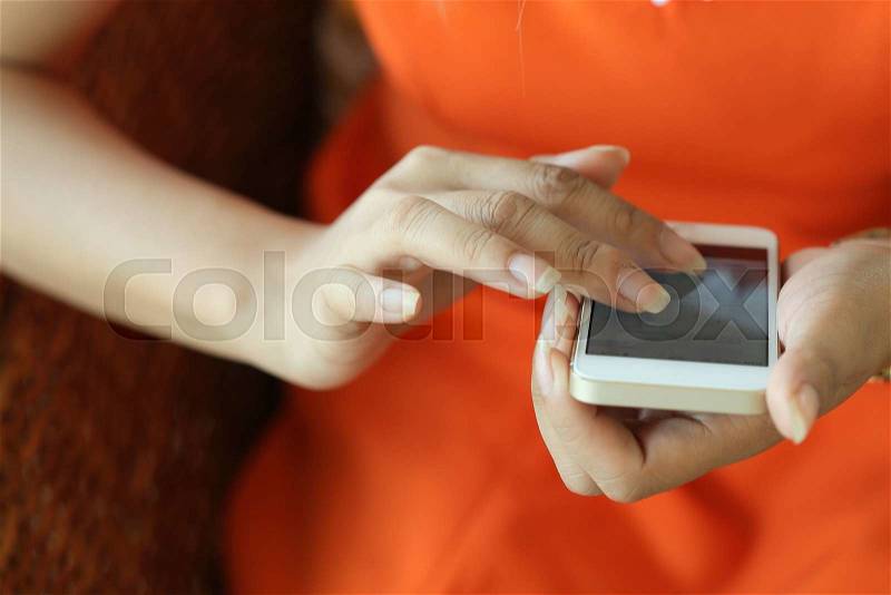 Female using a smart phone, hand touch on screen digital tablet, shallow depth of field image, stock photo