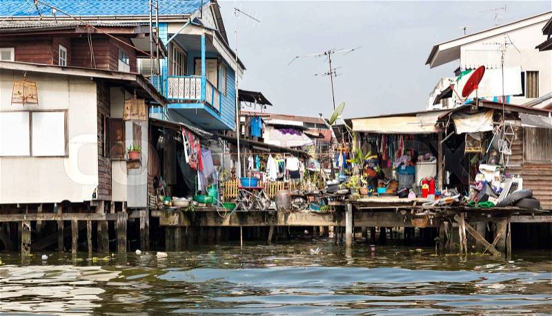 Shanty-town. Slum on dirty canal in Thailand, stock photo