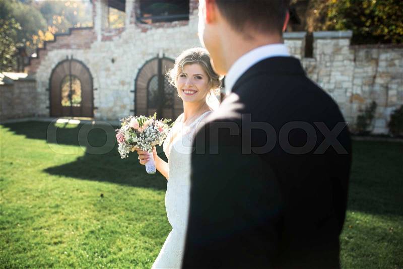 Bride and groom having fun in an old town, stock photo