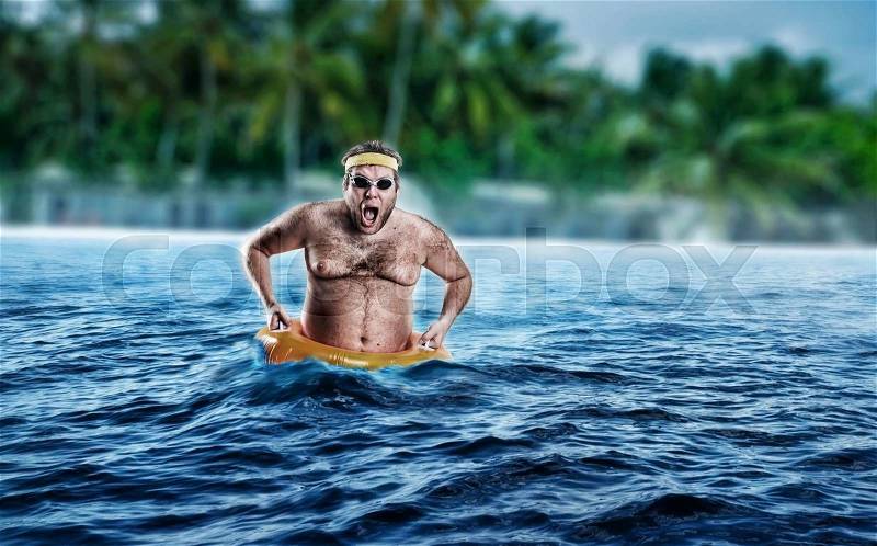Man has fun in the sea with life ring in the storm, stock photo