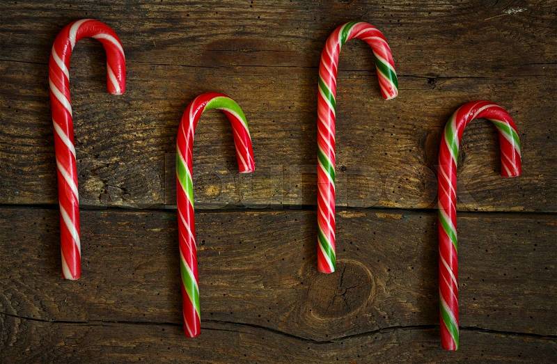 Candy canes on wooden boards - holidays background, stock photo