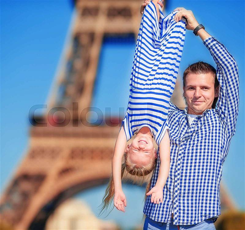 Happy family in Paris background Eiffel Tower. French summer holidays, travel and people concept, stock photo