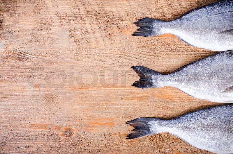 Fresh raw gilthead fishes on wooden background. Healthy food concept. Food frame, stock photo