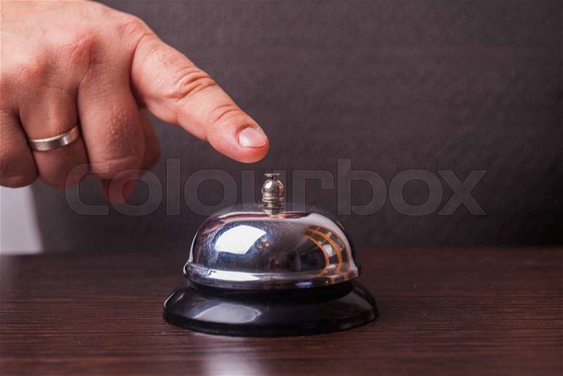 Close-up finger that presses of the service bell ring, stock photo