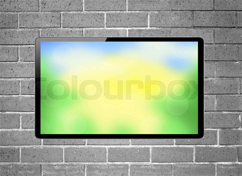 Blank screen LCD tv with bright nature hanging on a wall, stock photo
