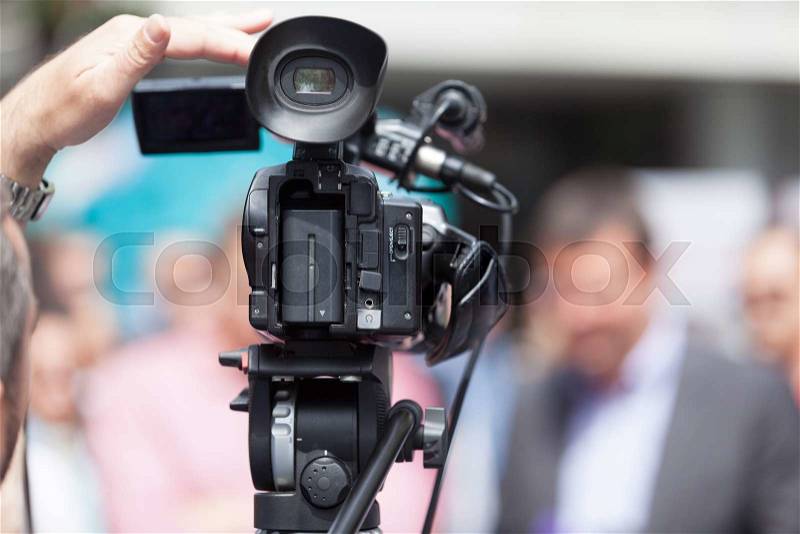 Filming an event with a video camera, stock photo