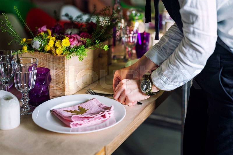 Cropped image of girl decorating dinner table. Cooking, profession, food and people concept - closeup of chef cook decorating dishes, stock photo