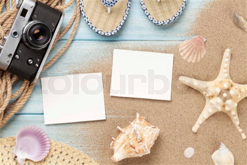 Travel and vacation photo frames and items on wooden table. Top view, stock photo