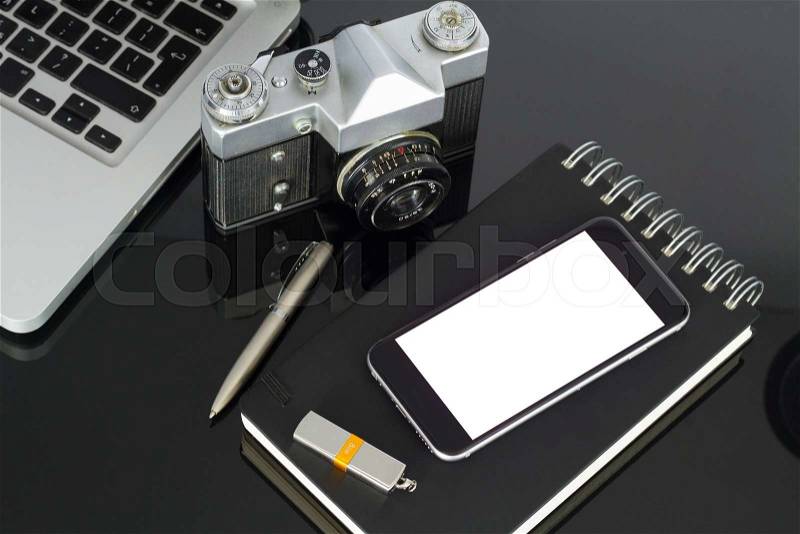 Office black glass desk table with phone, copy space on blank screen, stock photo