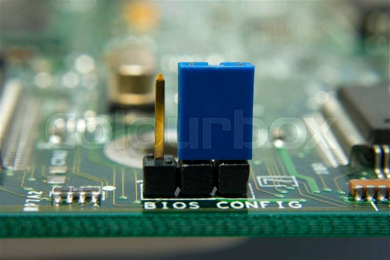 Computer motherboard circuit. Jumper BIOS config in the center, stock photo