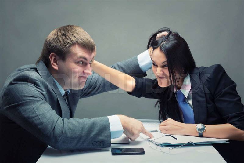 Two young caucasian office worker starting to fight, stock photo