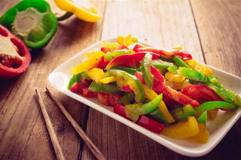 Stir fired mix color of sweet peppers on old wood, Vegetarian food , stock photo